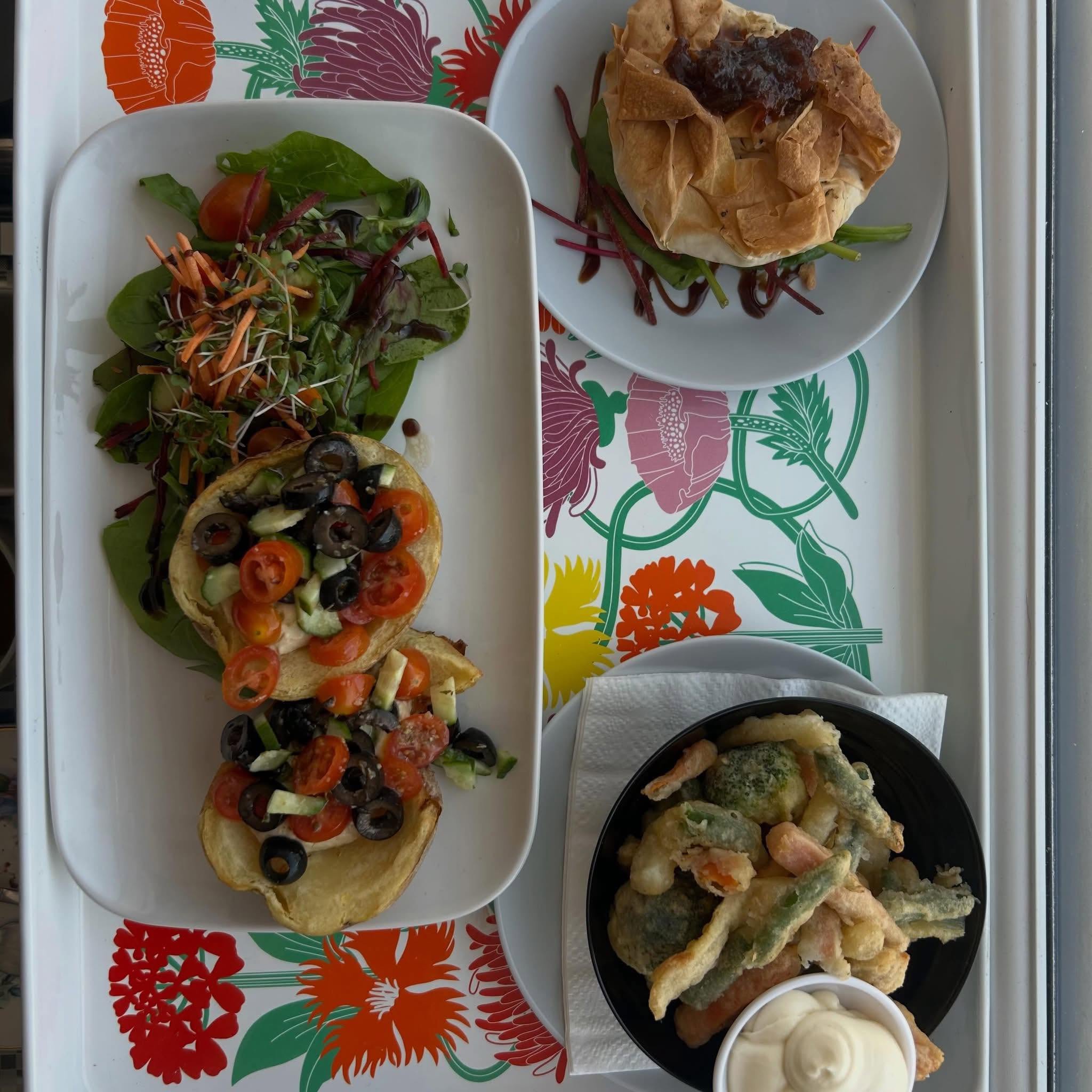 Vegan sharing plate with potato skins, sausage roll and tempura vegetables